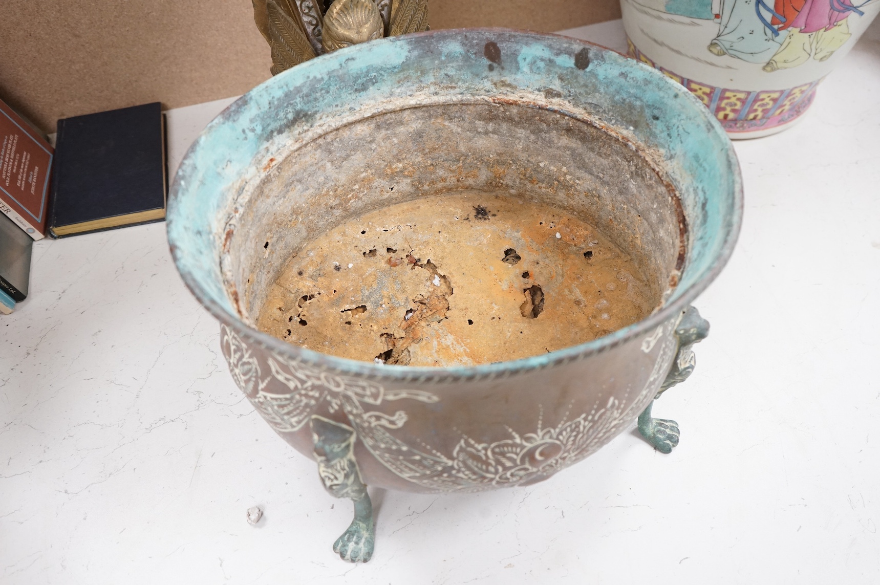 A brass fan shaped fireguard, a riveted jug and four footed planter. Fan shaped fire guard 63cm high. Condition - poor to fair